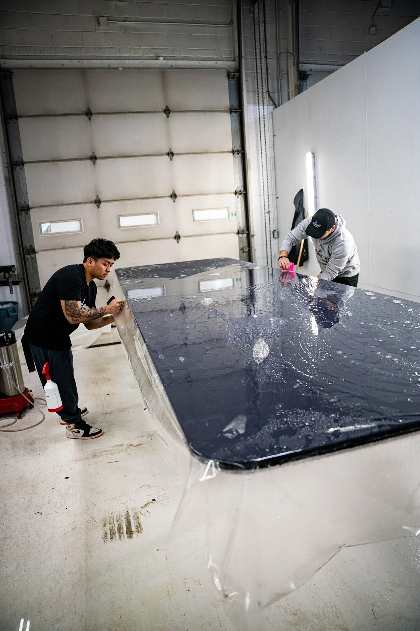 Technician applying clear protection film to a premium countertop