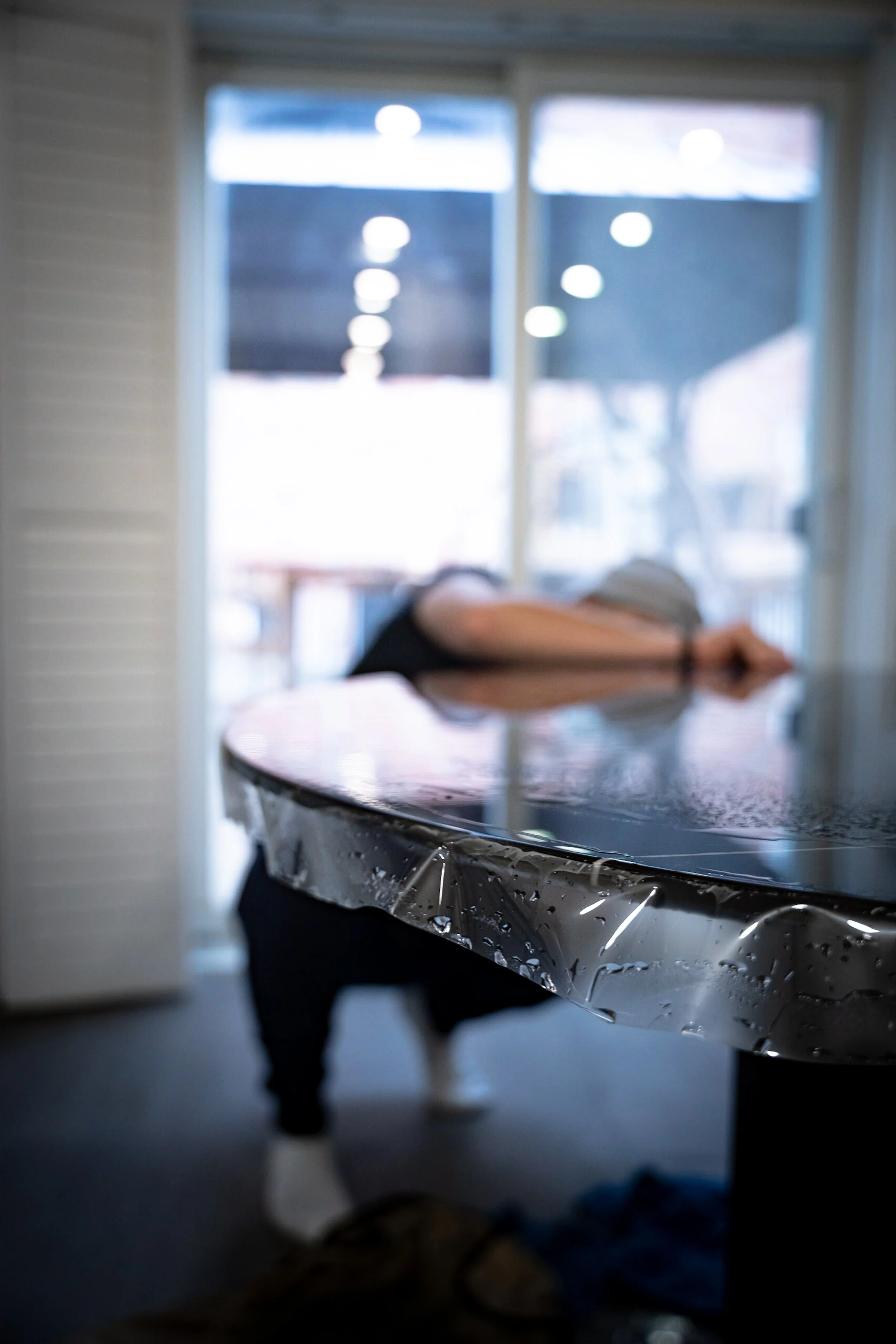 Clear countertop protection film being positioned over a stone surface
